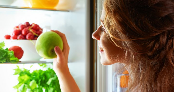 A teen eating some fruit.