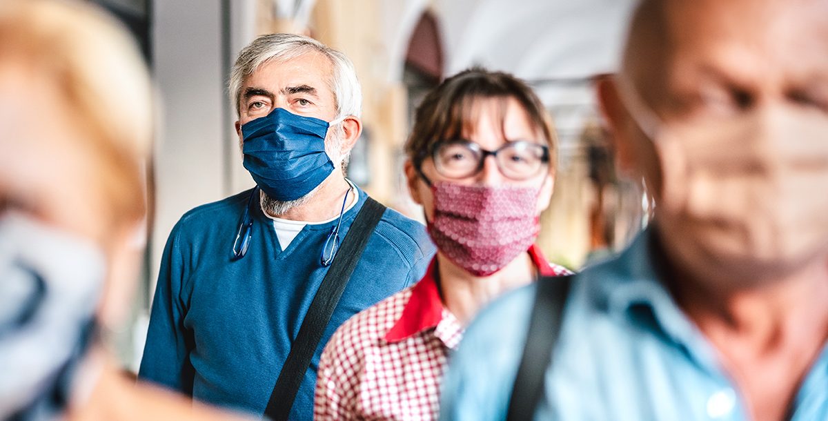 People navigating a crowded area during COVID-19.