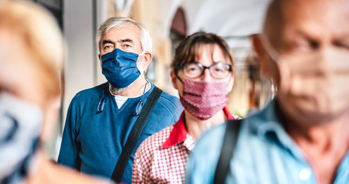 People navigating a crowded area during COVID-19.