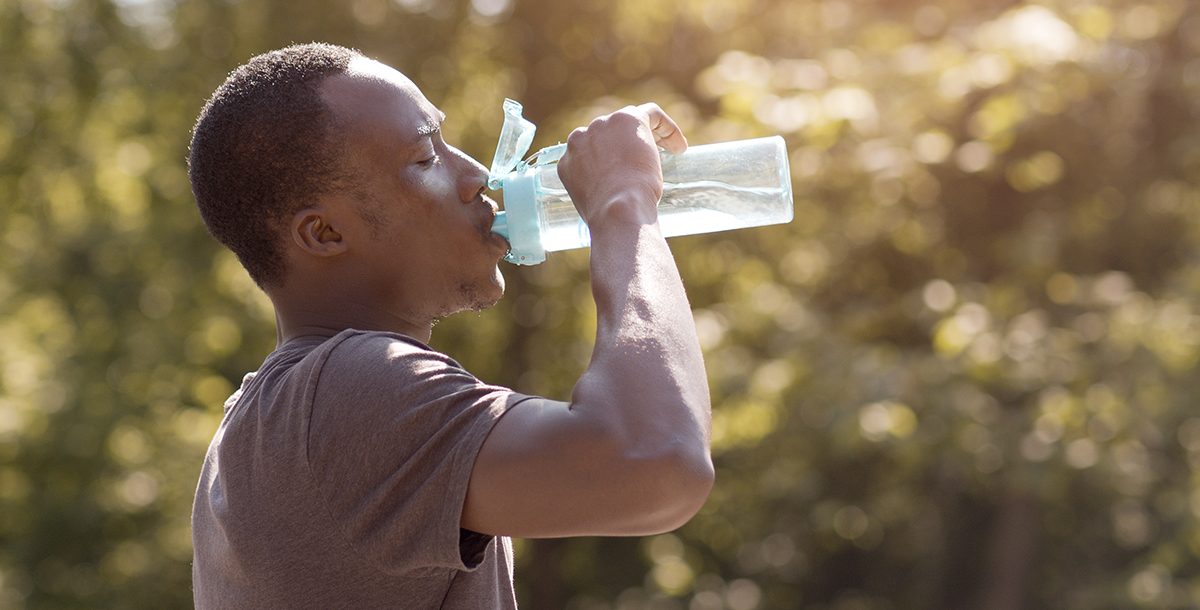 A man staying hydrated in the summer