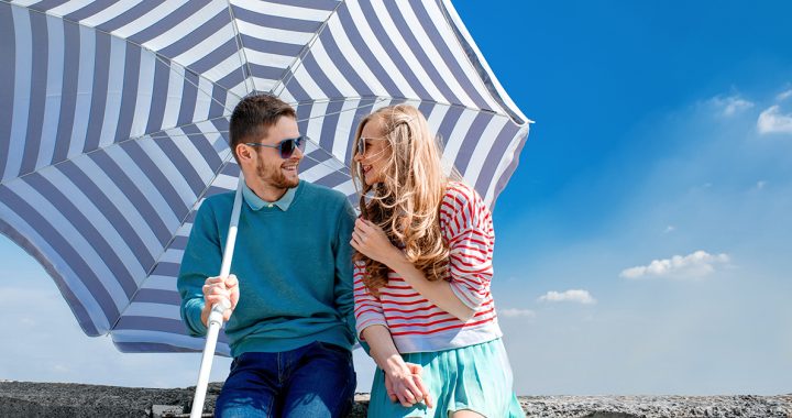 a couple using an umbrella