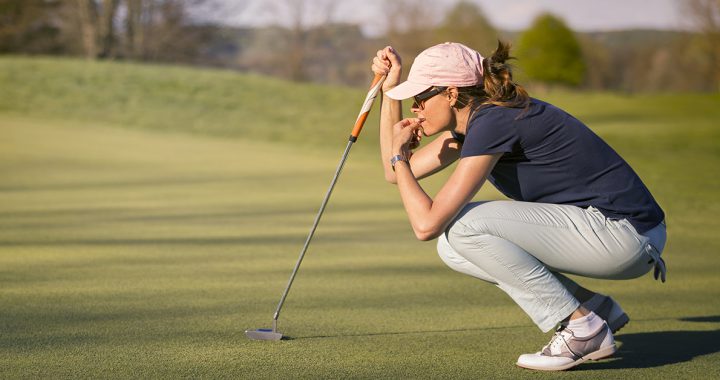 A woman playing golf.